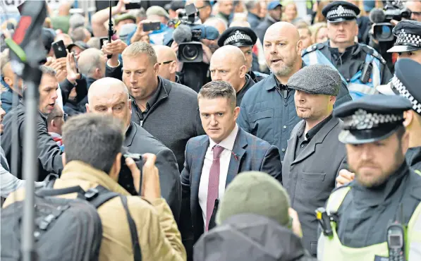  ??  ?? English Defence League founder Tommy Robinson with supporters outside the Old Bailey yesterday, above, while rival protests were held nearby, right