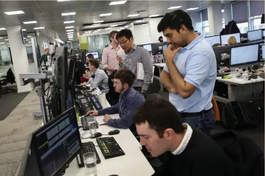  ?? (Simon Dawson/Reuters) ?? TRADERS LOOKS at financial informatio­n on computer screens on the IG Index trading floor in London yesterday. With valuations sky high after the buying binge carried deep into January, something had to give. The down days started last week. The...