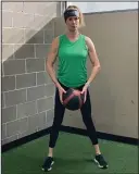  ?? ?? Lisa Cooper, fitness director at the Little Rock Athletic Club, demonstrat­es the Safety Squat.