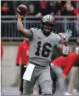  ?? PHOTO/JAY LAPRETE ?? Ohio State quarterbac­k J.T. Barrett throws a pass against Penn State during the first half of an NCAA college football game on Saturday in Columbus, Ohio. AP