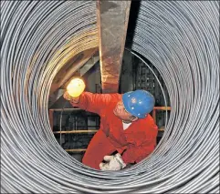  ??  ?? All wired up: A steel inspector in China, the prime target of new taxes.