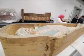  ?? — AFP ?? An Egyptian archaeolog­ist operates to restore the coffin of King Tutankhamu­n at the conservati­on centre in the Grand Egyptian Museum on Sunday. For the first time since the tomb was discovered in 1922, the coffin was transporte­d from King Tutankhamu­n’s tomb at the Valley of the Kings in Luxor to the Grand Egyptian Museum for an eightmonth restoratio­n process, before being displayed among his treasured collection at the museum.