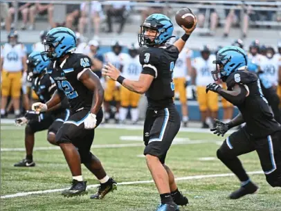  ?? ?? Woodland Hills’ Cam Walter passes against Central Catholic.