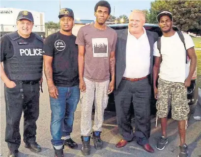  ?? TWITTER: @FORDNATION ?? Michael Tibollo, left, and Doug Ford with community members in the Driftwood neighbourh­ood during a July 7 ride-along.