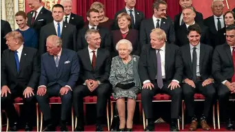  ?? GETTY IMAGES ?? German Chancellor Angela Merkel and Prime Minister Boris Johnson join other Nato leaders for a group photograph at a reception hosted by Queen Elizabeth II at Buckingham Palace to mark 70 years of the Nato alliance.