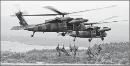  ??  ?? This file photo of Japanese Ground Self-Defense Force troops abseiling from helicopter­s an exercise at Higashi-Fuji firing range at the foot of Mount Fuji.