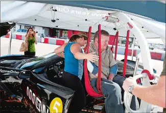  ?? PHOTOS BY ISAAC BREKKEN/AP PHOTO ?? Indy Racing League driver Sam Schmidt exits his modified Corvette Tuesday in Las Vegas. Schmidt, paralyzed from the neck down in a crash 16 years ago, is set to receive the first autonomous vehicle driver’s license in the U.S.