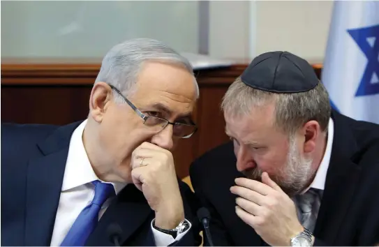  ?? (Gali Tibbon/Reuters) ?? PRIME MINISTER Benjamin Netanyahu speaks with then-cabinet-secretary Avichai Mandelblit during a cabinet meeting in 2015.