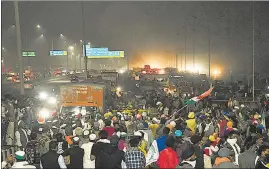  ??  ?? Farmers block a part of the Delhi-Meerut National Highway during their protest march against the new farm laws in New Delhi on Thursday.