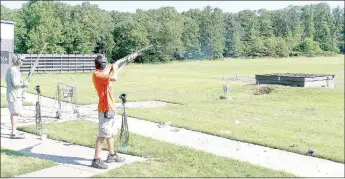  ?? Keith Bryant/The Weekly Vista ?? Joe Falcon, left, stands by while Dakota Falcon, 15, takes his shot during the Cancer Challenge trap shooting tournament.