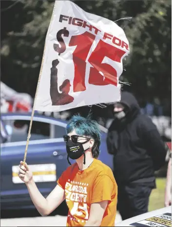  ?? ASSOCIATED PRESS ?? CRISTIAN CARDONA, AN EMPLOYEE AT A MCDONALD’S, minimum wage Tuesday in Orlando, Fla. attends a rally for a $15 an hour