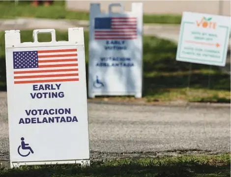  ?? RICARDO RAMIREZ BUXEDA/ORLANDO SENTINEL ?? Signs outside the Early Voting Center at the Southwest Branch of the Orange County Public Library in Dr. Phillips, on August 16 a week before the primary.