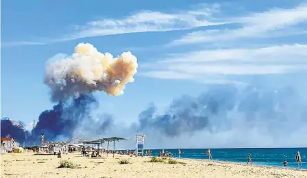  ?? UGC VIA AP ?? Rising smoke can be seen from the beach at Saki after explosions Tuesday at a Russian military airbase near Novofedori­vka, Crimea.