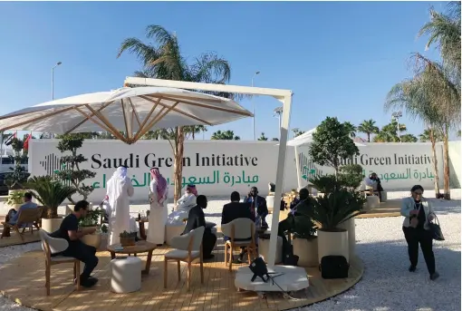  ?? ?? Visitors sit outside the Saudi Green Initiative forum near the COP27 climate conference venue in Sharm El Sheikh, Egypt. Saudi Energy Minister Prince Abdulaziz bin Salman Al Saud has announced a raft of green projects, from beefed up tree planting pledges to fresh solar energy projects, at the UN summit to highlight the Kingdom’s pioneering efforts to control global warming. — ap