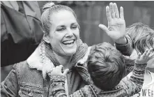  ?? Elaine Thompson / Associated Press ?? Teacher Shelly Storm high-fives Louis Morgenroth at Wallingfor­d Child Care Center in Seattle. A workforce crisis is forcing many in the child care industry to turn to Wall Street-like business tactics.