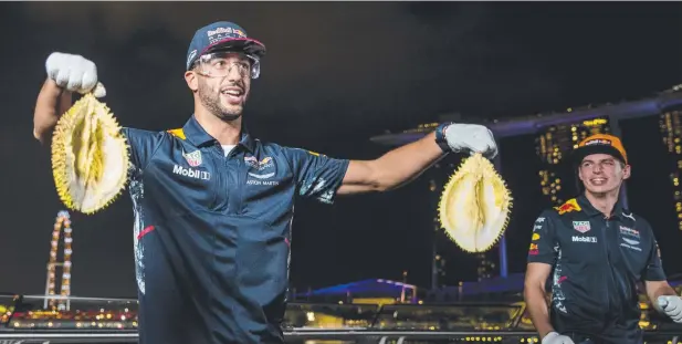  ?? Picture: GETTY IMAGES ?? LOCAL FUN: Aussie Daniel Ricciardo (left) and teammate Max Verstappen of Netherland­s attempt to open local fruit durian at a Red Bull event ahead of the Formula One Grand Prix of Singapore.