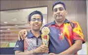  ?? HT PHOTO ?? Divyansh Srivastava (left) poses with the winners trophy alongwith his coach Yogendra Agarwal.