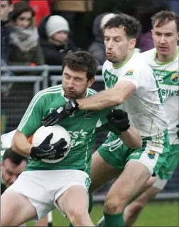  ??  ?? Ballyduff’s Thomas Slattery is closely marked by Paul Kennelly, Ballydonog­hue, during the North Kerry SFC semi-final replay in Brosna