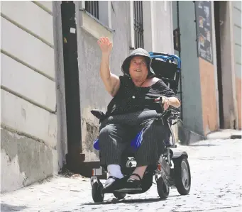  ??  ?? Writer Ken Donohue’s mom Linda Donohue navigates the steep hills in Bratislava, the capital of Slovakia.