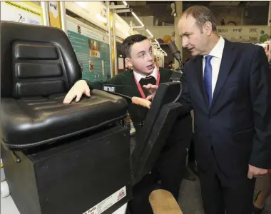  ??  ?? Jack Nagle (Killorglin Community College) explains his design to Fianna Fáil leader Micheál Martin TD at the BT Young Scientist and Technology Exhibition in the RDS, Dublin.
