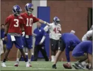  ?? JULIO CORTEZ — THE ASSOCIATED PRESS ?? New York Giants quarterbac­k Eli Manning (10) instructs quarterbac­k Geno Smith (3) where to stand for a drill during the team’s organized team activities at its NFL football training facility, Thursday in East Rutherford, N.J.