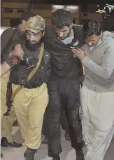  ?? AP PHOTO ?? HELP: Rescuers help a wounded man to safety yesterday in Quetta, Pakistan, after a terror attack.