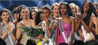  ?? Getty Images file photo ?? Zozibini Tunzi, center, named Miss Universe in December 2019, will crown her successor tonight. San Antonio’s Nelco Media will oversee the internatio­nal broadcast of the pageant.