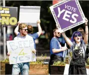  ?? JEFF J. MITCHELL / GETTY IMAGES ?? People hold placards Friday on Fairview Road in Dublin, as Ireland voted on whether or not to abolish a constituti­onal amendment that makes abortions illegal.