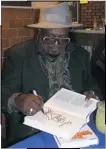  ?? STAFF PHOTO BY TIFFANY WATSON ?? George Clinton, founder of the band Parliament-Funkadelic, signs his book for a fan Wednesday at Lefty’s BBQ in Waldorf. His memoir is titled, “Brothers be like, George Ain’t This Funkin Kinda Hard On You?”