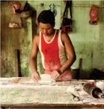  ??  ?? HAND WORK. A baker kneads bread at his stall at the Nyaung U public market.