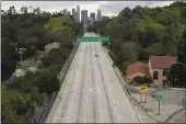  ?? MARK J. TERRILL — THE ASSOCIATED PRESS FILE ?? Extremely light traffic moves in the mid-afternoon along the 110Harbor Freeway toward downtown Los Angeles.