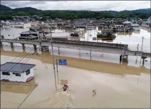  ?? AP/Kyodo News/KOJI HARADA ?? Houses are partly submerged in floodwater­s from heavy rains, in Kurashiki, Okayama prefecture, southweste­rn Japan, on Sunday.