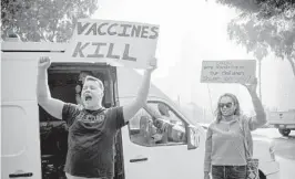  ?? MORGAN LIEBERMAN/THE NEW YORK TIMES ?? Ian Jameson and Nelly Ruiz join in a protest of COVID-19 vaccine mandates at public schools Nov. 16 in Los Angeles.