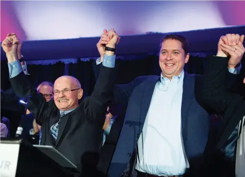  ?? JACQUES BOISSINOT / THE CANADIAN PRESS ?? Conservati­ve Leader Andrew Scheer, right, raises arms on Saturday with Richard Lehoux, left, the party’s choice to run in the riding of Beauce in the 2019 federal election. Lehoux was the mayor of Saint-Elzear, Que., and the former president of an associatio­n of Quebec municipali­ties.