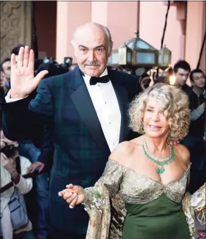  ?? Jack Guez / AFP via Getty Images ?? In this file photo taken Dec. 7, 2004 British actor Sean Connery and his wife, Micheline Roquebrune, arrive for the presentati­on of “Alexendre,” directed by Oliver Stone, during the 44th Internatio­nal Film Festival in Marrakesh. Connery, best known for playing fictional spy James Bond in seven films, has died at age 90, his family told the BBC on Saturday. The Scottish actor, who was knighted in 2000, won numerous awards during his decades-spanning career, including an Oscar, three Golden Globes and two Bafta awards.