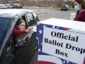  ?? Timothy Hurst, Daily Camera file ?? James Fox cast his ballot while Broomfield administra­tive analyst Nancy Andzulis is ready to hand Fox a sticker on Nov. 3.