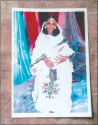  ??  ?? A photograph of Letay, the deceased wife of 40-year-old Tigrayan Abraha Kinfe Gebremaria­m, is seen in her family’s shelter in Hamdayet.