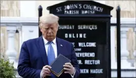  ?? Patrick Semansky/Associated Press ?? President Donald Trump holds a Bible as he stands outside St. John's Episcopal Church across from the White House on Monday.