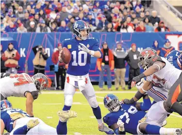  ?? BILL KOUSTROUN/AP FILE ?? The criticism of Giants QB Eli Manning (10) has subsided since he directed New York to consecutiv­e victories overSan Francisco and Tampa Bay. Today he will be going against the defending world champion Eagles.