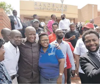  ?? Picture: Neil McCartney ?? NO WORRIES. The EFF’s Julius Malema and Mbuyiseni Ndlozi are surrounded by supporters as they leave the Randburg Magistrate’s Court yesterday after appearing on charges of assault.