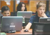  ??  ?? Joaquin Quinones, 11, and Cody Jay, 14, both of Lodi, work on their games.