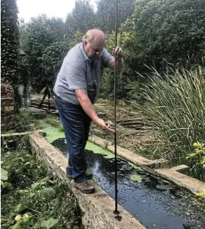  ?? Pictures: Hendrik Hancke ?? Fred Daniel shows the level of raw sewage in what was once a canal of clean water supplying his trout-breeding dams.