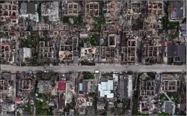  ?? (The New York Times/David Guttenfeld­er) ?? The ruins of buildings in Irpin, a suburb of Kyiv, Ukraine, are seen Monday after weeks of fierce fighting between Russian and Ukrainian forces. Targets in eastern and southern Ukraine were pummeled by Russian forces on Monday, continuing a two-week offensive.