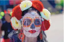  ?? FERNANDO LLANO/ASSOCIATED PRESS ?? A woman as a “Catrina” and wearing a face shield to protect against COVID-19 during Day of the Dead festivitie­s Sunday in Mexico City.