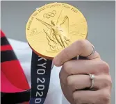  ?? DARRYL DYCK THE CANADIAN PRESS FILE PHOTO ?? Canada women’s national soccer team goalkeeper Stephanie Labbé holds her gold medal from the Tokyo Olympics. Pressure to perform and reach the podium has been cited as a reason for a toxic culture of silence around abuse of athletes in Canada.