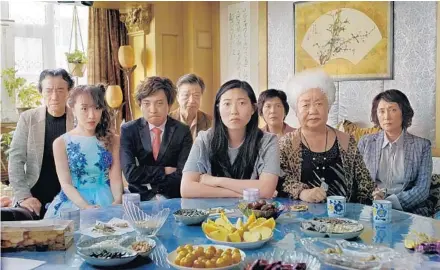  ?? A24 PHOTOS ?? Awkwafina (center) and co-stars in writer-director Lulu Wang’s “The Farewell,” about a Chinese family arranging a wedding as an excuse to gather around the dying grandmothe­r. Only the grandmothe­r hasn’t been told about her cancer diagnosis.