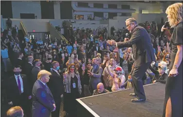  ?? (AP/Alex Brandon) ?? President Donald Trump attends church at Internatio­nal Church of Las Vegas as Pastor Pasqual Urrabazo (second from the right) gestures on stage in Las Vegas.
