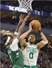  ?? GETTY IMAGES ?? The Celtics’ Jayson Tatum looks to shoot against the Bucks’ Bobby Portis on Friday in Milwaukee.