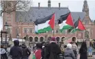  ?? PETER DEJONG/AP ?? Pro-Palestinia­ns demonstrat­ors wave flags as they protest outside the United Nations’ highest court during hearings in The Hague, Netherland­s, on Monday.