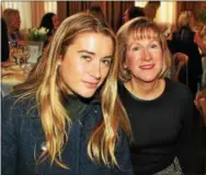  ??  ?? Emma Rumbaugh of Berwyn and her seat mate Susan Zaharchuk of Blue Bell wait for the fashion show to begin.